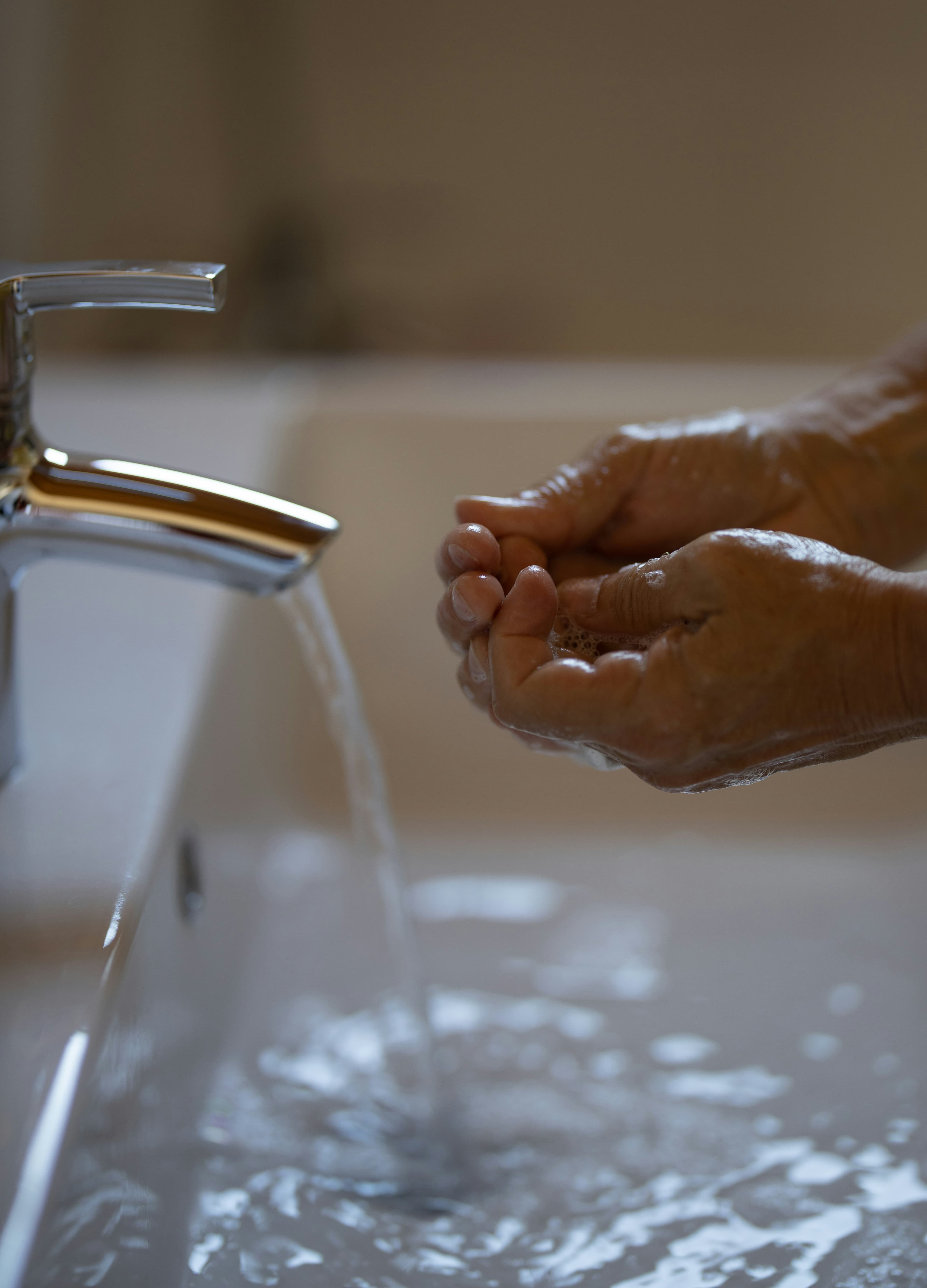 Washing hands with clean tap water — drinking water safety FAQs